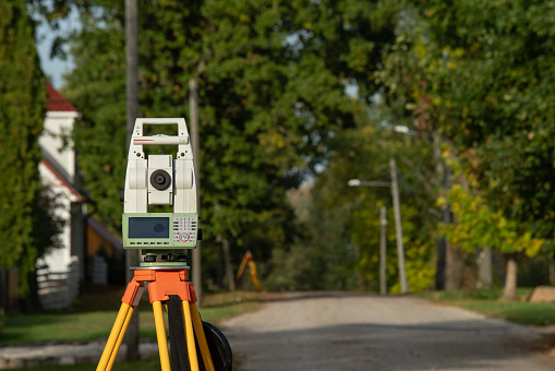 Geodesy instrument, one man system, view along the street, high resolution photo. the streets of a small town