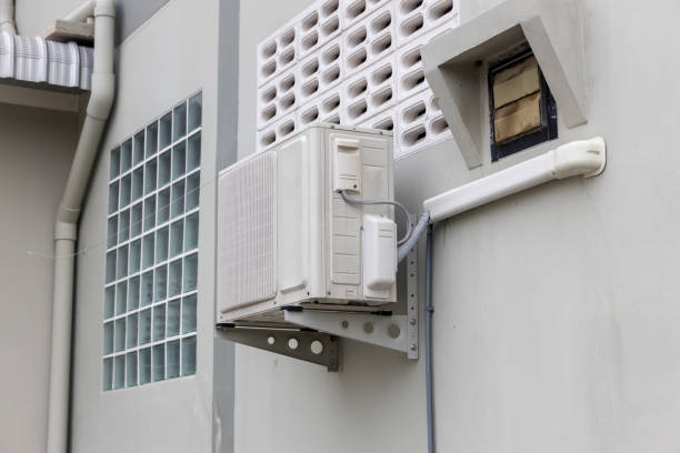 istock Air conditioner compressor installed in old building. Outdoor split wall type air conditioner compressor unit inverter installed on the outside of the building. Air conditioner compressor outdoor unit 1281695546