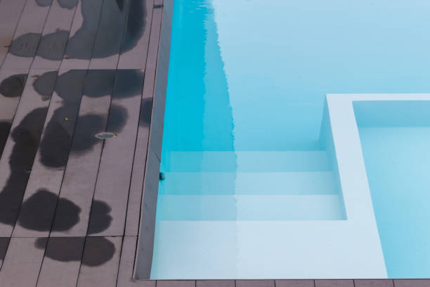 istock Swimming Pool. swimming pool bottom caustics ripple and flow with waves background. Swimming pool of luxury hotel. 1281695597