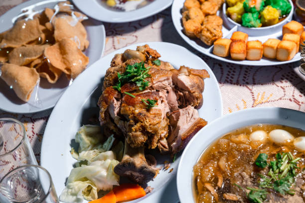 pork hock in german with sauces delicious food. deep fried pork knuckle ,thai style serve with seafood sauce. crispy pork knuckle or german pork hocks on wood board. - shank sauerkraut german cuisine pork imagens e fotografias de stock