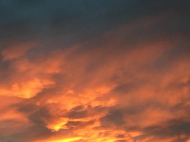 istock Smoke from a chimney at dawn reflects light and looks like fire 1281696833