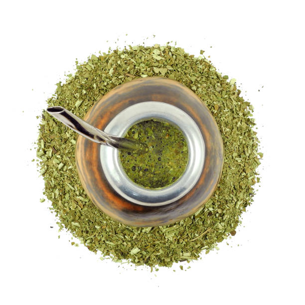 Yerba mate tea in calabash gourd with steel bombilla isolated top view stock photo