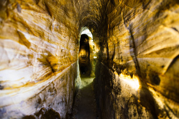istock Ancient narrow underground passage in sandstone at old underground monastery 1281699784