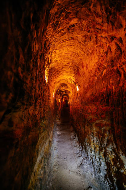 istock Ancient narrow underground passage in sandstone at old underground monastery 1281699803
