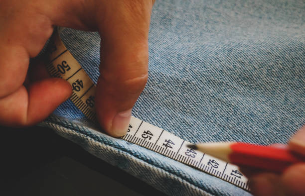 istock tailor measures tape jeans where to cut them 1281699941