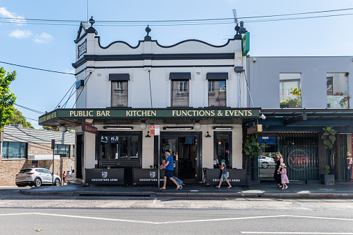 Sydney NSW Australia March 1st 2020 - Facade of a old Pub in Balmain on a sunny summer afternoon and a family walking along the footpath