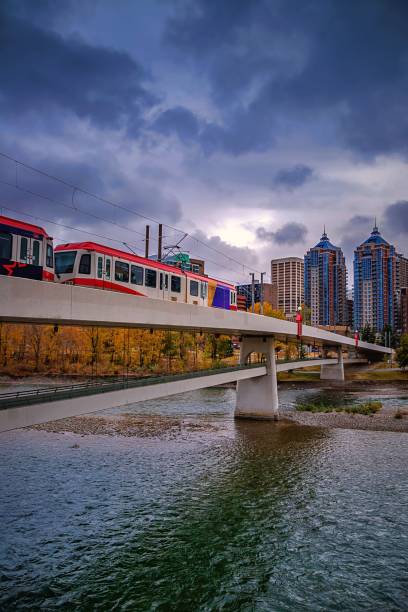 istock City Train Crossing The River Under Moody Clouds 1281702817