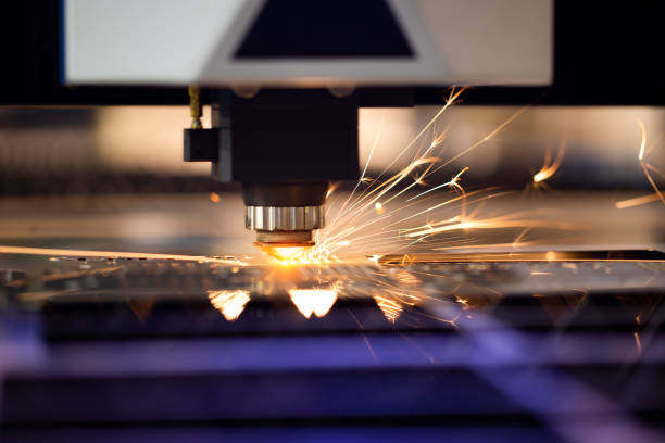 istock Automated programmed machine for metal processing. Industrial laser machine cuts out parts in sheet steel. Heat. Sparks during operation of production machine at factory. 1281702916