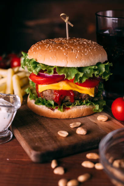 istock Home made fresh tasty burger with lettuce and cheese on wooden rustic table. 1281703018