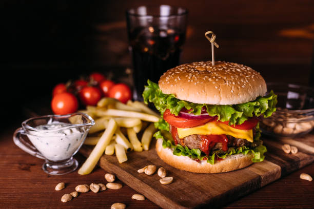 istock Home made fresh tasty burger with lettuce and cheese on wooden rustic table. 1281703019