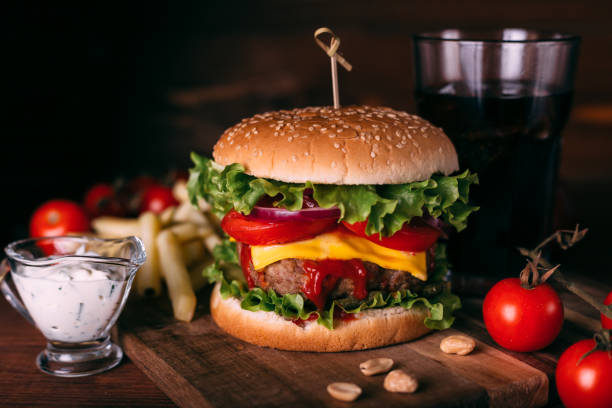 istock Home made fresh tasty burger with lettuce and cheese on wooden rustic table. 1281703029