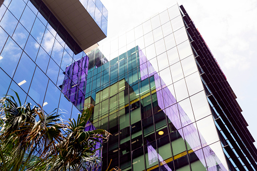 Low angle view of modern glass office buildings with reflection, skyscrapers, background with copy space, full frame horizontal composition