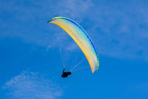 istock Colourful paraglider on a blue sky background. Extreme sport. 1281704013
