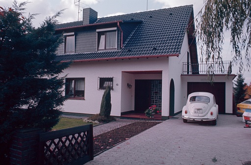 Bonn, North Rhine Westphalia, Germany, 1978. Surburban. The new single-family house with garden and garage. Also: vehicles.