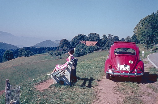 Bavaria, Germany, 1964. Travelers take a break from driving and enjoy the landscape.