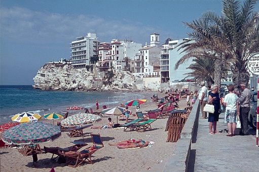 Playa de Benidorm, Alicante, Costa Blanca, Spain, 1965. Beach section and promenade of Playa de Benidorm. Furthermore: hotels, tourists, beach visitors and buildings.