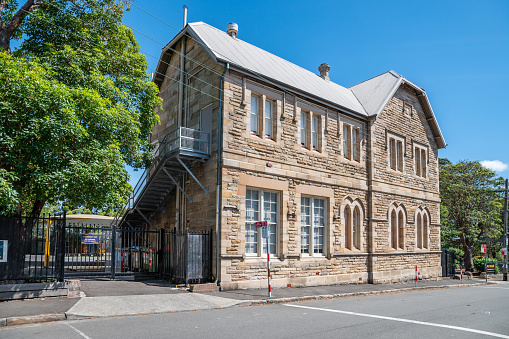 Sydney NSW Australia March 1st 2020 - Sandstone wall with White Frame and Arched Windows on a Public School Facade in Balmain on a sunny autumn afternoon