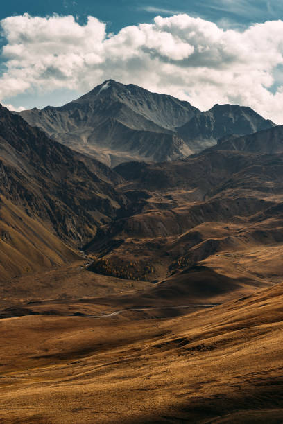 istock Incredibly beautiful mountain landscape, vertical view. Mountain peaks in the sun. Panoramic view of the autumn mountains. Landscape with views of mountain valleys. Clouds over the mountains 1281705014