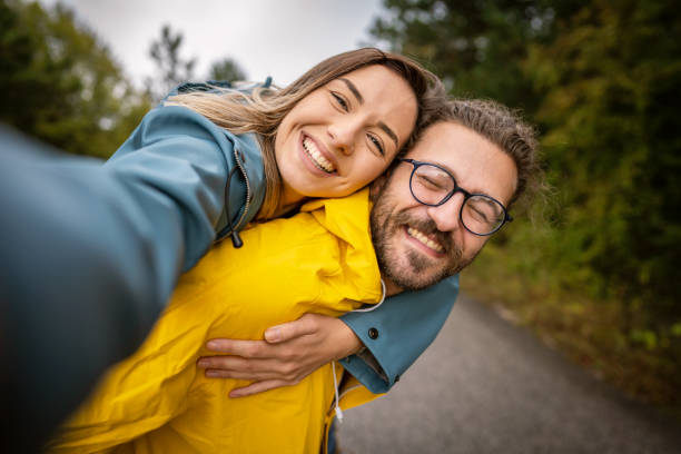 istock Young happy couple taking selfie in nature 1281705295