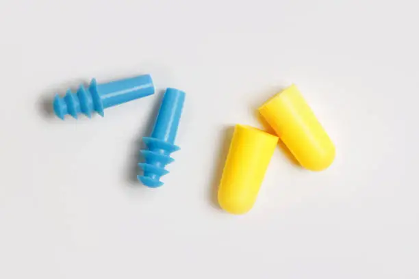 Two tipes of earplugs isolated on white. Silicone and foam pairs