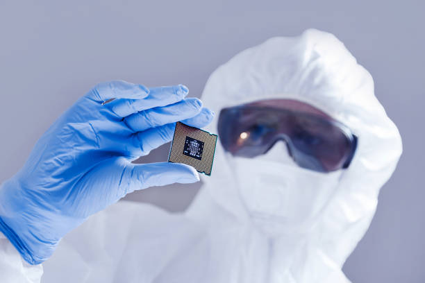 istock Close-up view on a new semiconductor microchip in gloved hand of computer scientist. Modern technology and hardware development 1281705350