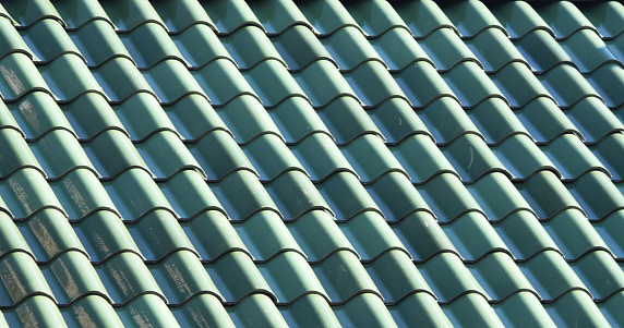 Green roof tiles on sloped roof.