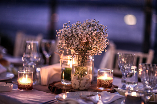 Candles burning in place setting
