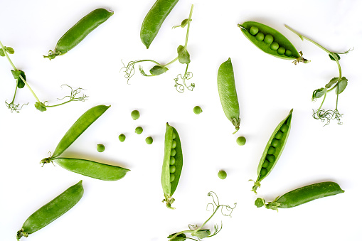 Flat lay natural light green snap peas isolated on white pattern