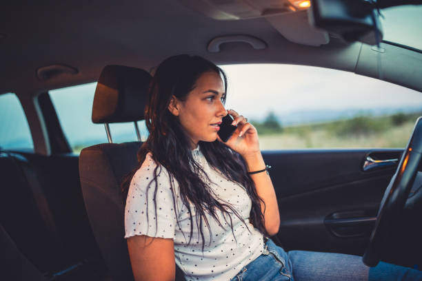 istock Female talking on the phone in the car 1281709701
