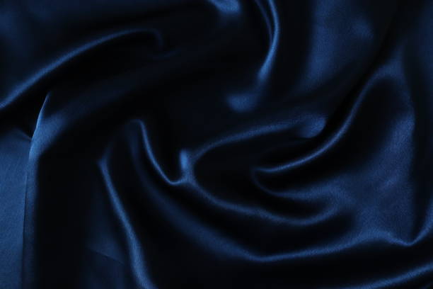 istock Smooth elegant dark blue silk or satin fabric. Draped luxury cloth texture for design 1281712340