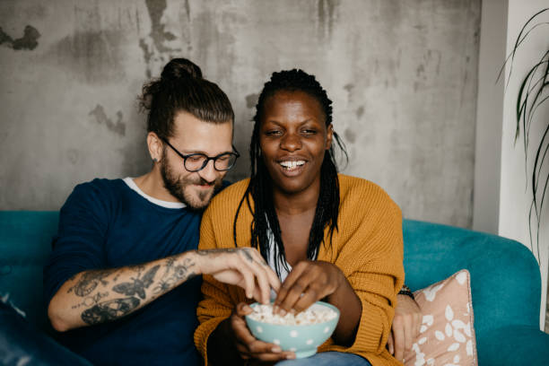 istock Couple relaxing on the couch at home watching TV 1281713225