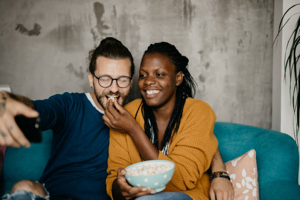 istock Couple relaxing on the couch at home watching TV 1281713256
