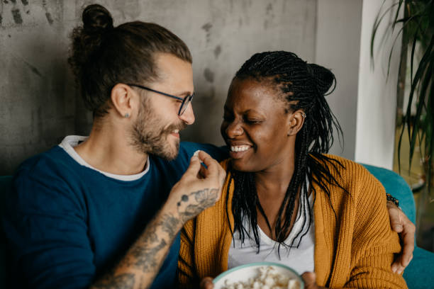 istock Couple relaxing on the couch at home watching TV 1281713320