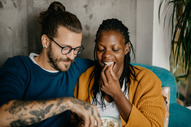 istock Couple relaxing on the couch at home watching TV 1281713353