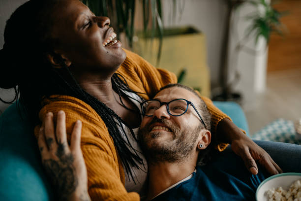 istock Couple relaxing on the couch at home watching TV 1281713402