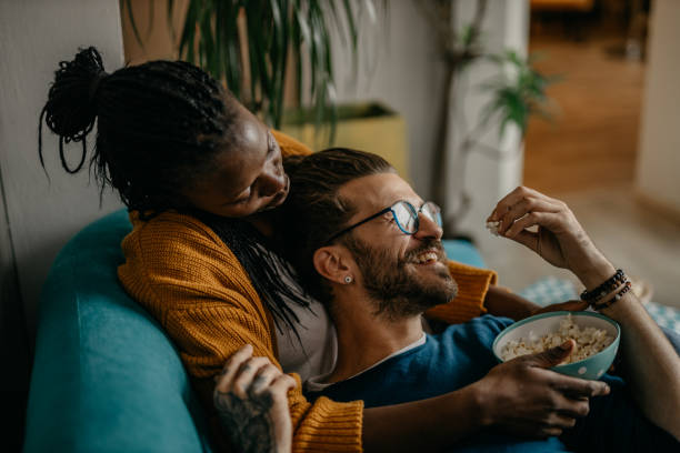 Couple relaxing on the couch at home watching TV