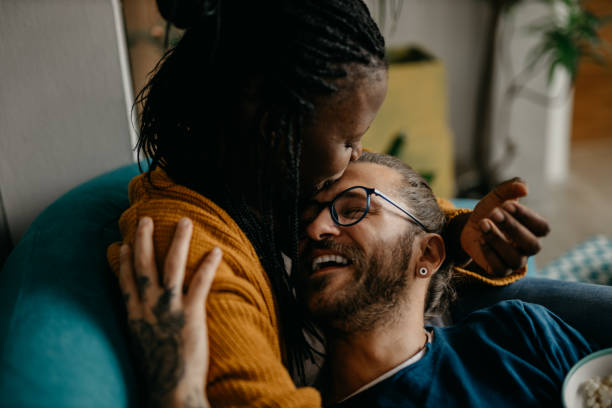 istock Couple relaxing on the couch at home watching TV 1281713422