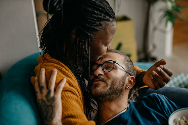 istock Couple relaxing on the couch at home watching TV 1281713428