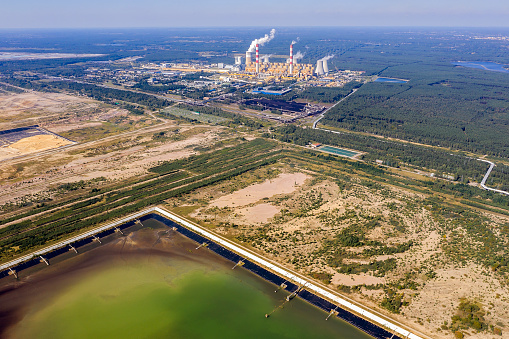 A large coal fired thermal power plant and liquid waste storage lake, aerial view.