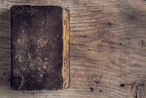istock Ancient book with weathered leather book cover on table, top view. Copy space for text. Textured blank cover. 1281715905