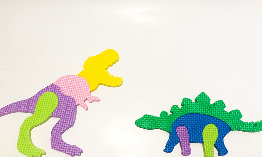 dino toy with colorful body on white background