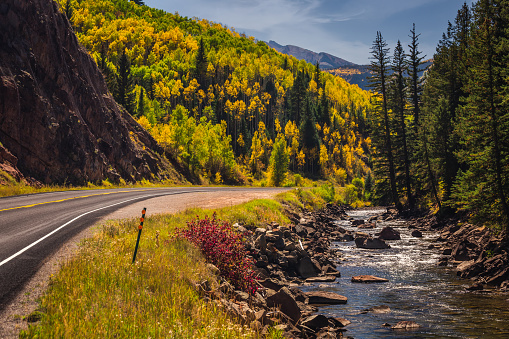 American flag with beautiful yellow autumn aspen tree leaves at the background. Taken in Black Hawk city turned into gambling destination of Colorado Rocky Mountains, USA.