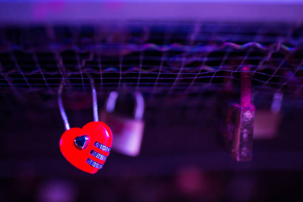 istock Padlock in shape of heart on footbridge by night 1281719238