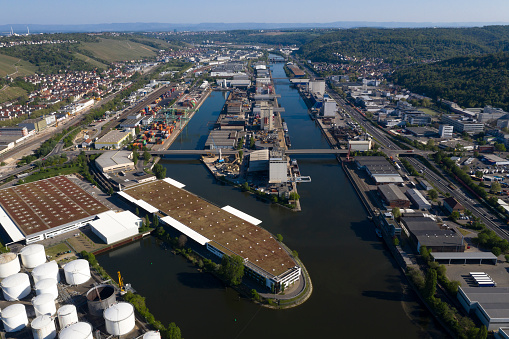 Large group of industrial estates located along the river in Germany, aerial view.
