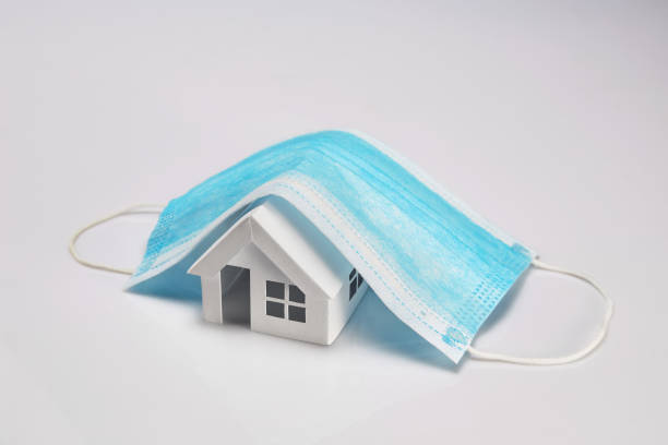 istock Paper house model cover by a mask isolated on white background 1281720076