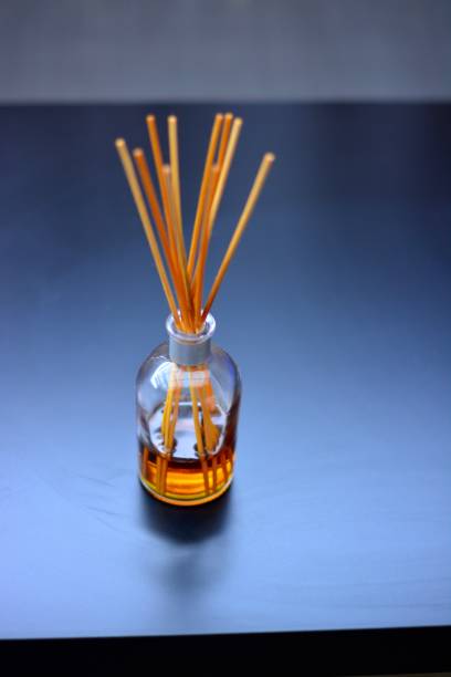 istock Fragrance Sticks, blurred background on a dark surface. 1281721102