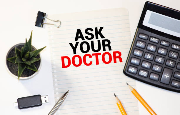 istock ASK YOUR DOCTOR word on Chalkboard with Coffee Cup, view from above 1281723100