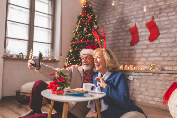 senior couple having virtual party with friends on christmas day - cell human cell plant cell virus imagens e fotografias de stock