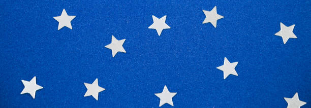 istock Silver stars on blue background. Christmas and new year concept. Banner format. 1281723748