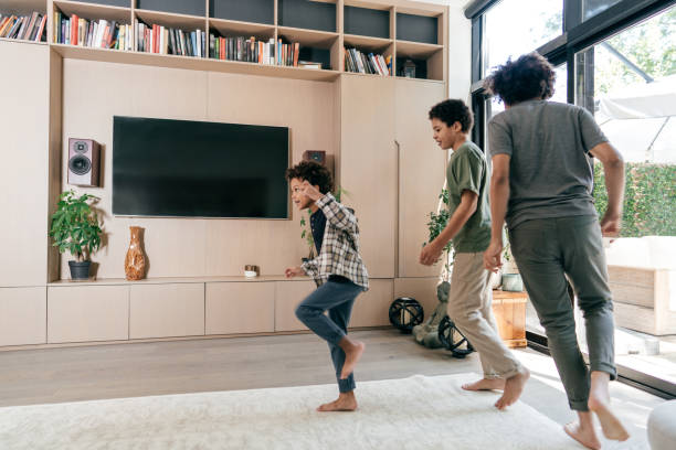 istock Siblings having little performance  in the living room 1281725448